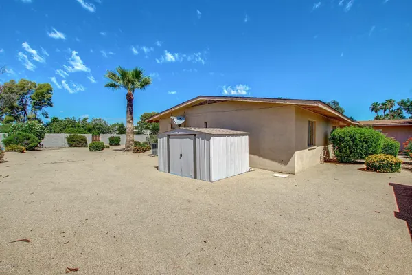 a view of house with swimming pool and yard