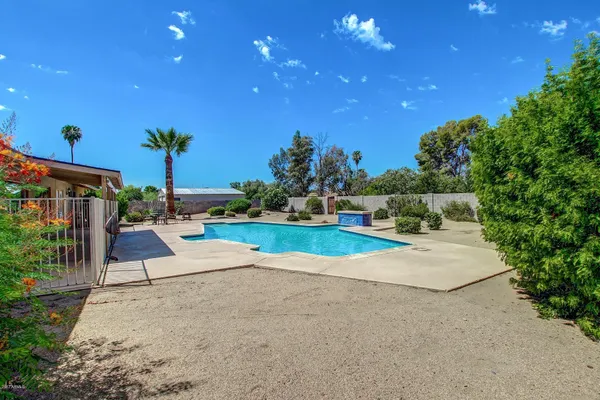 a view of a house with a tree in front of it