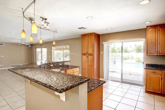 a kitchen with stainless steel appliances granite countertop a sink and a counter space