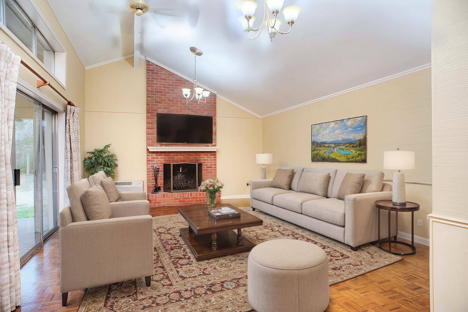 5270 Cole Road Memphis, TN 38120 - Photo 7 of 20 21x16 DEN - Features Include a Brick Fireplace, Parquet Flooring, Vaulted Smooth Ceiling, Wet Bar With Sink, and Sliding Doors to a Covered Porch. Transom Windows Provide Abundant Natural Light. This photo is virtually staged.