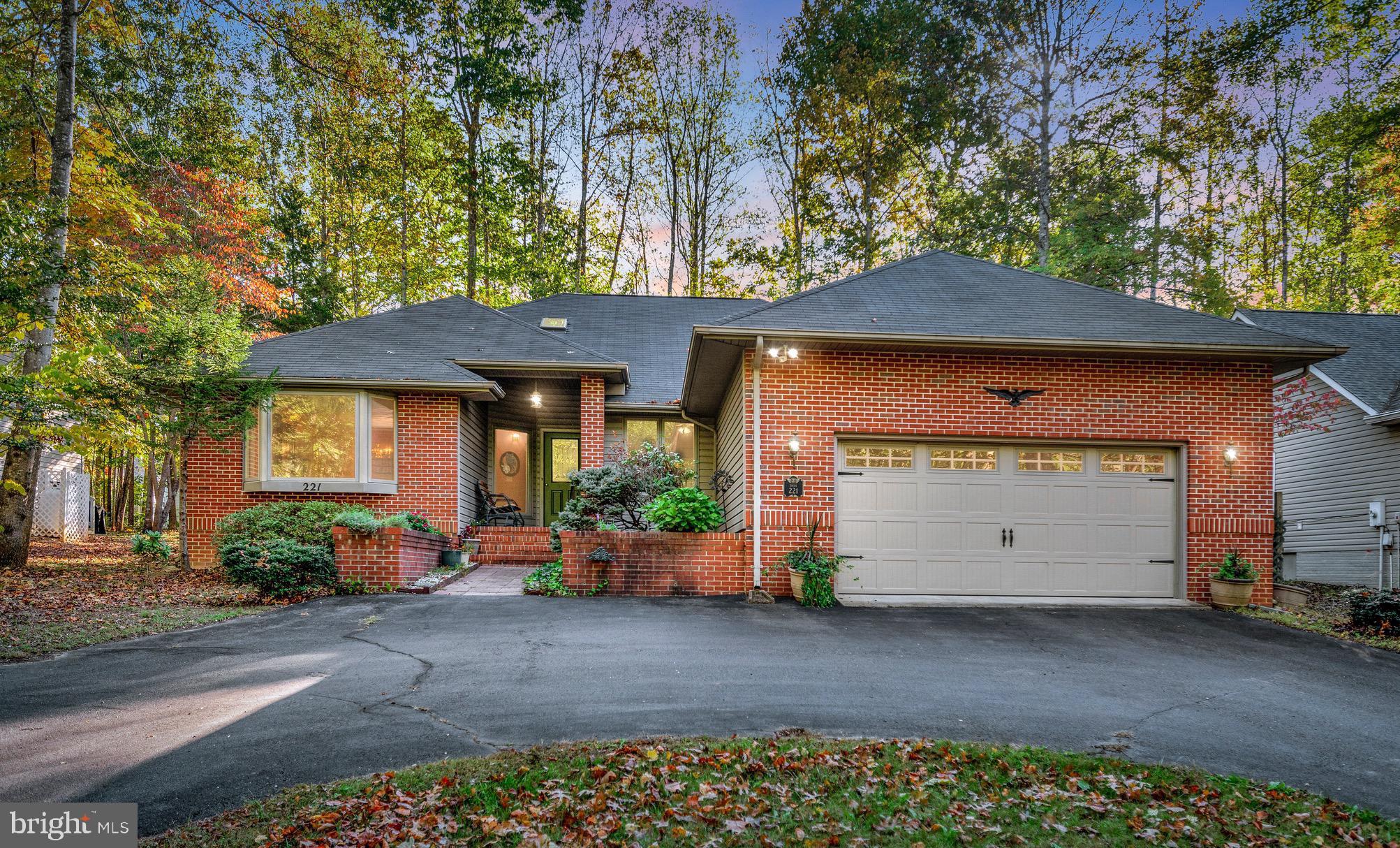 221 Washington Street Locust Grove, VA 22508 - Photo 1 of 48 a front view of a house with garden