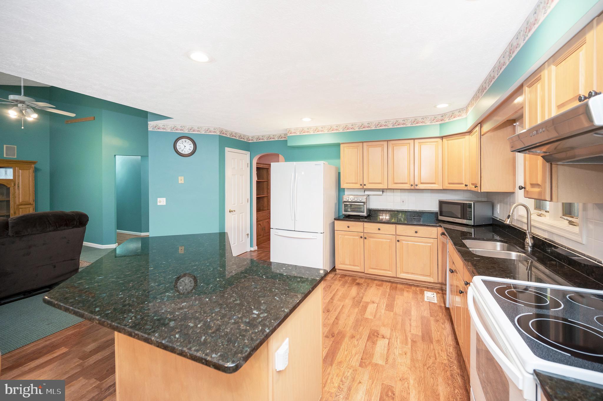 221 Washington Street Locust Grove, VA 22508 - Photo 12 of 48 a kitchen with stainless steel appliances granite countertop a sink stove and refrigerator