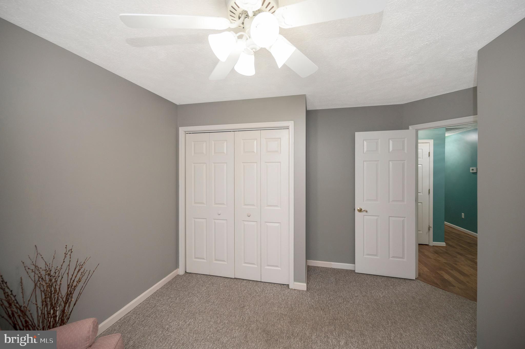 221 Washington Street Locust Grove, VA 22508 - Photo 23 of 48 an empty room with a ceiling fan and a window