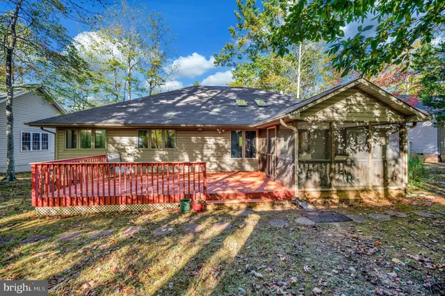 a view of a backyard with a small cabin and wooden fence