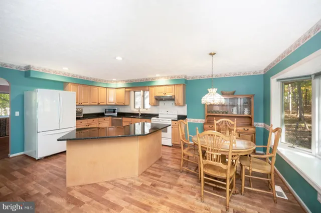 a dining room with furniture and a kitchen view