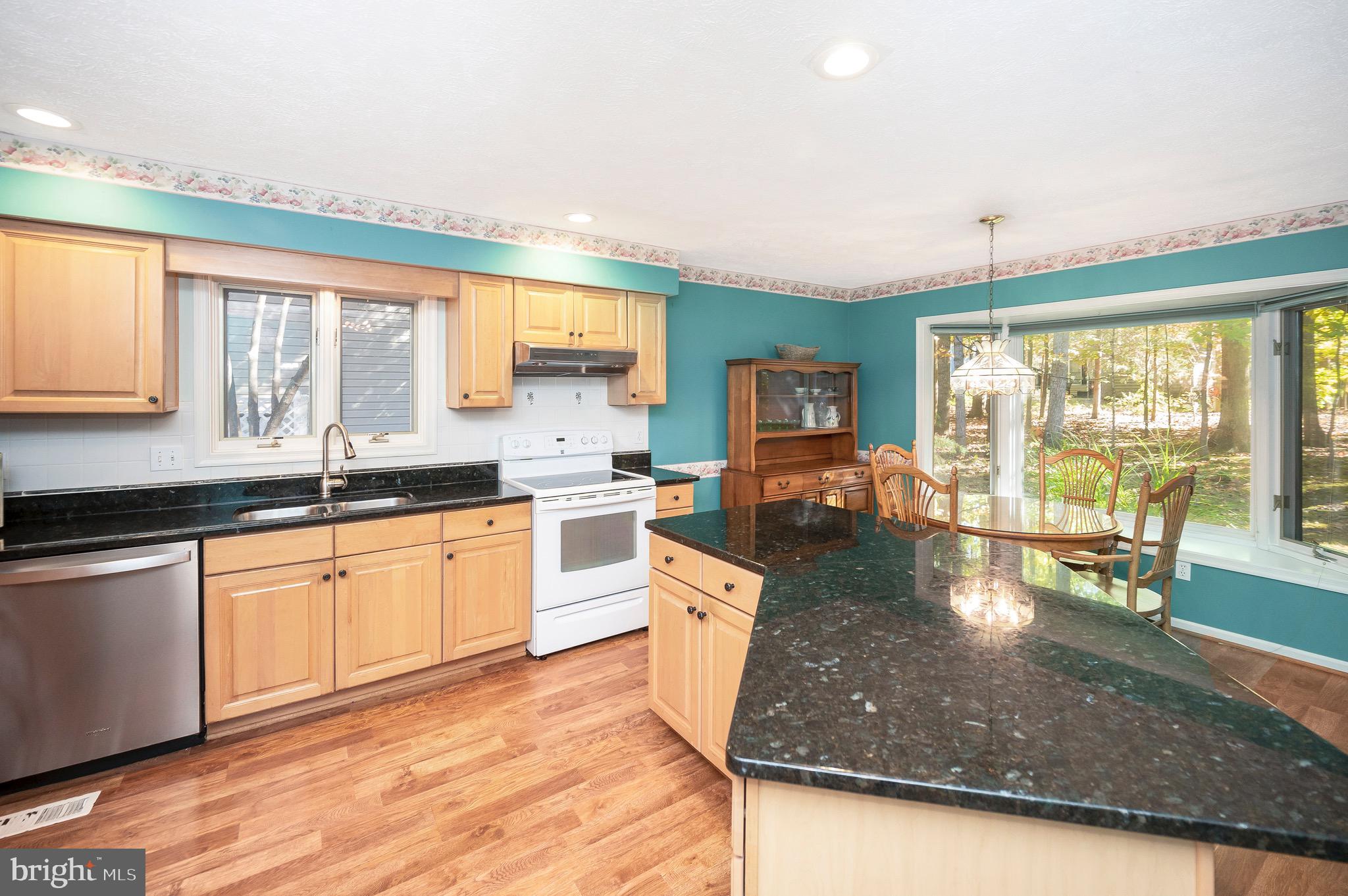 221 Washington Street Locust Grove, VA 22508 - Photo 9 of 48 a large kitchen with kitchen island a large window in it