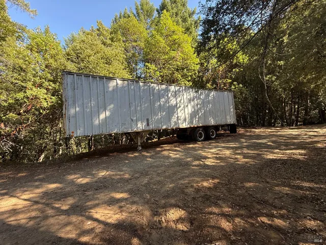 a view of a barn in the middle of a yard
