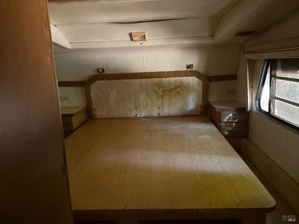 a bed sitting in a bedroom next to a window