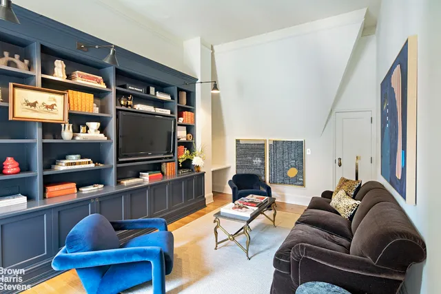 a dining room with furniture a chandelier and wooden floor