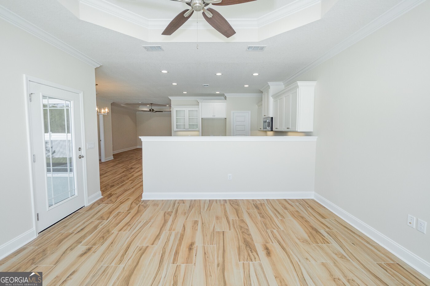 214 The Villas Way Kingsland, GA 31548 - Photo 12 of 47 a view of a room with wooden floor and a kitchen space