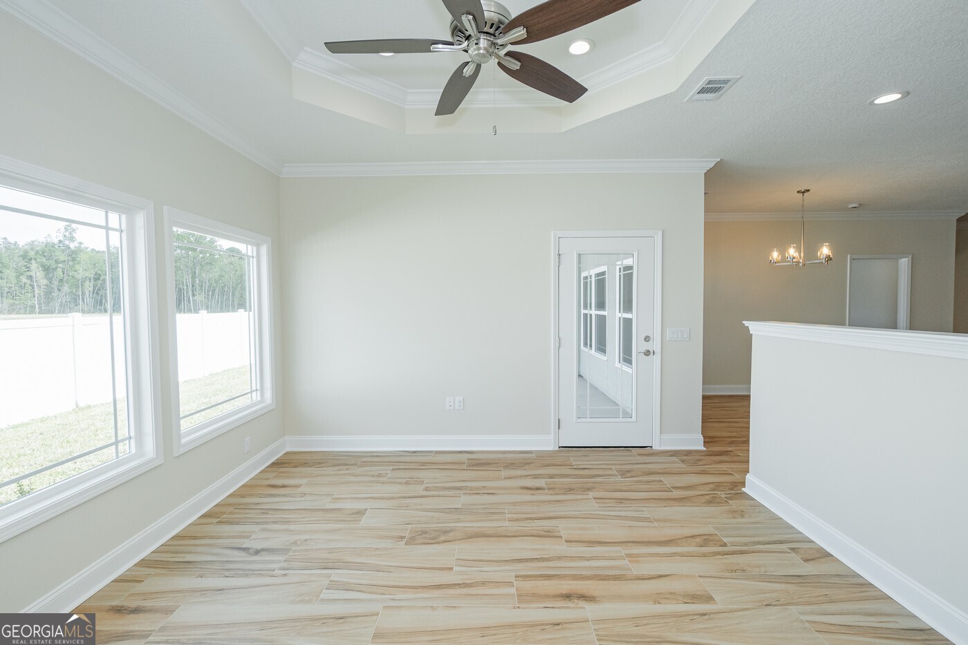 214 The Villas Way Kingsland, GA 31548 - Photo 13 of 47 a view of an empty room with wooden floor and a window