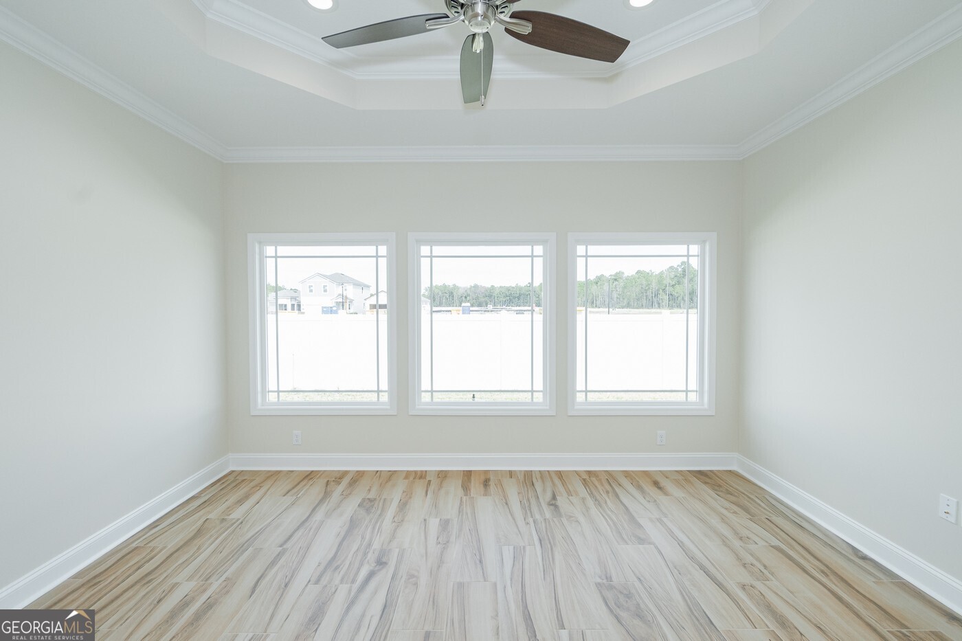 214 The Villas Way Kingsland, GA 31548 - Photo 14 of 47 an empty room with a window and wooden floor