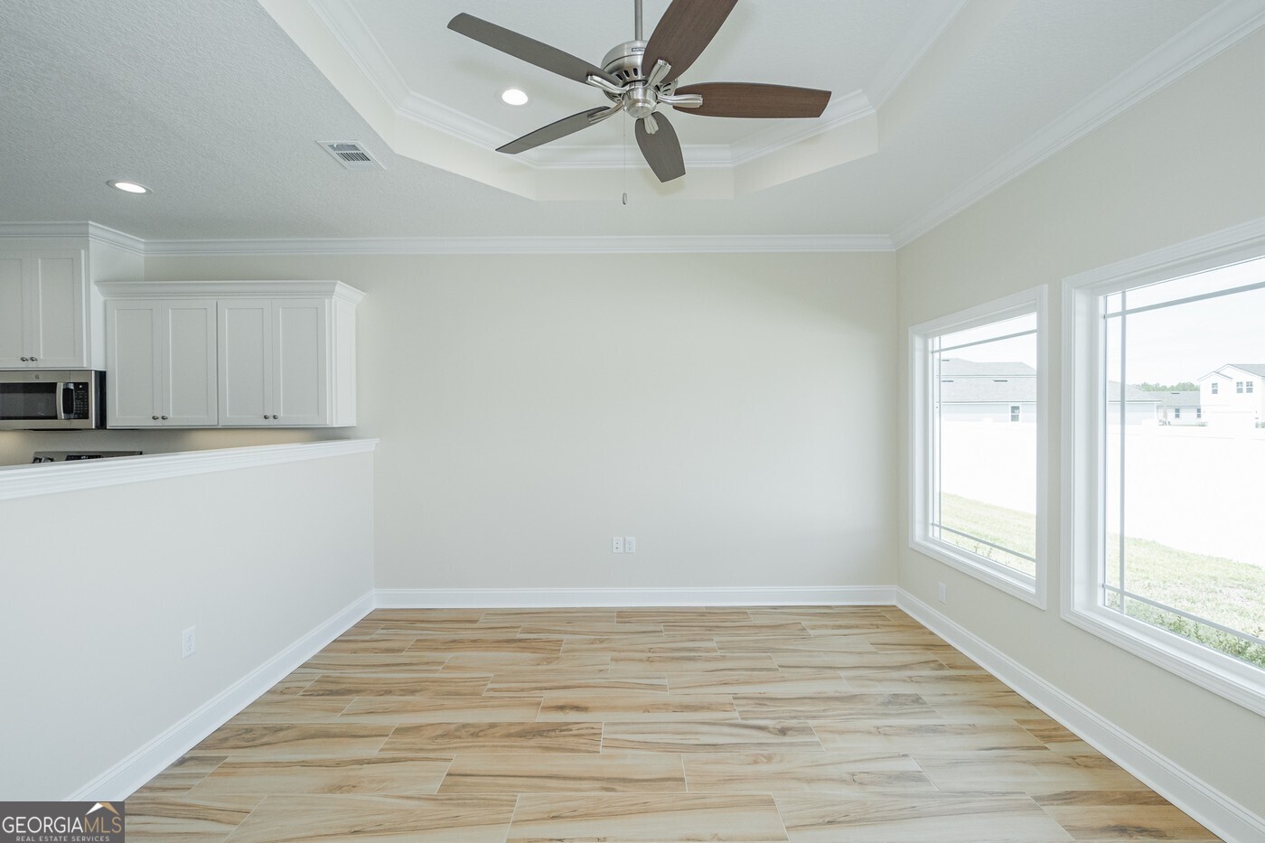 214 The Villas Way Kingsland, GA 31548 - Photo 15 of 47 wooden floor in an empty room with a window