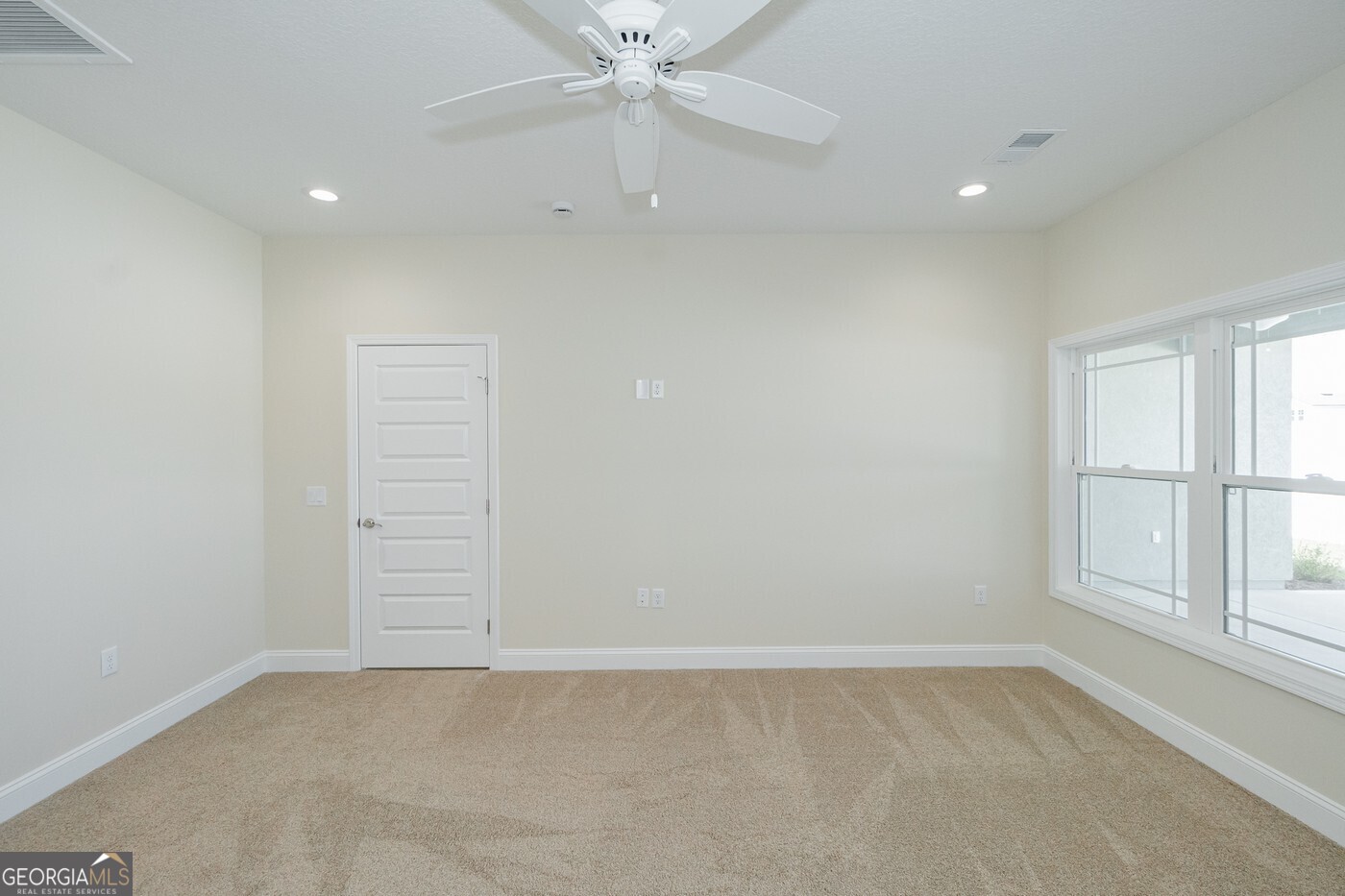 214 The Villas Way Kingsland, GA 31548 - Photo 21 of 47 an empty room with windows and ceiling fan