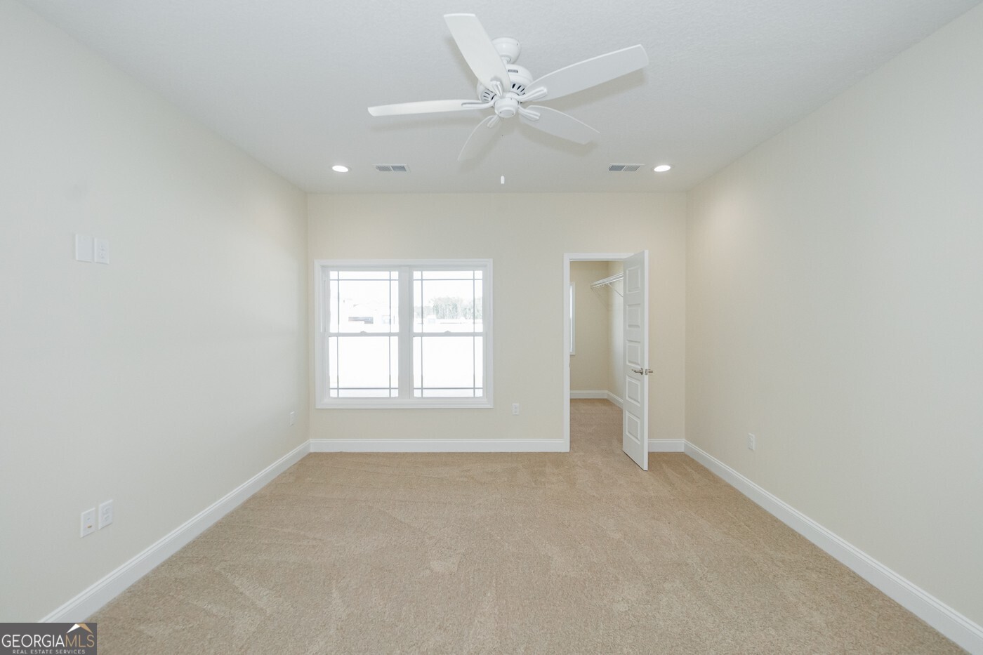 214 The Villas Way Kingsland, GA 31548 - Photo 22 of 47 an empty room with a window and a ceiling fan