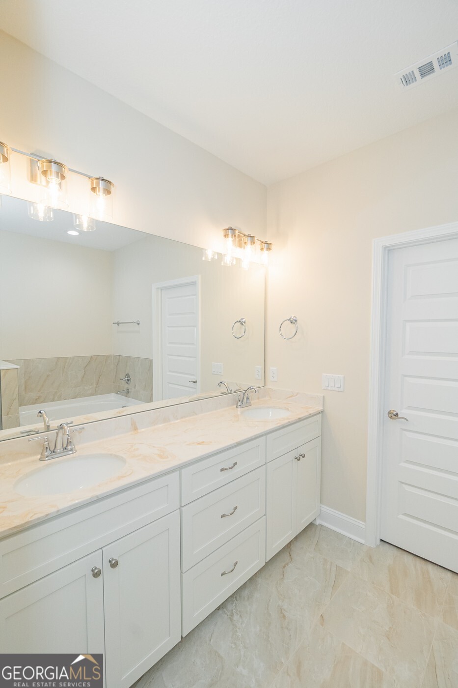 214 The Villas Way Kingsland, GA 31548 - Photo 24 of 47 a bathroom with a double vanity sink and a mirror