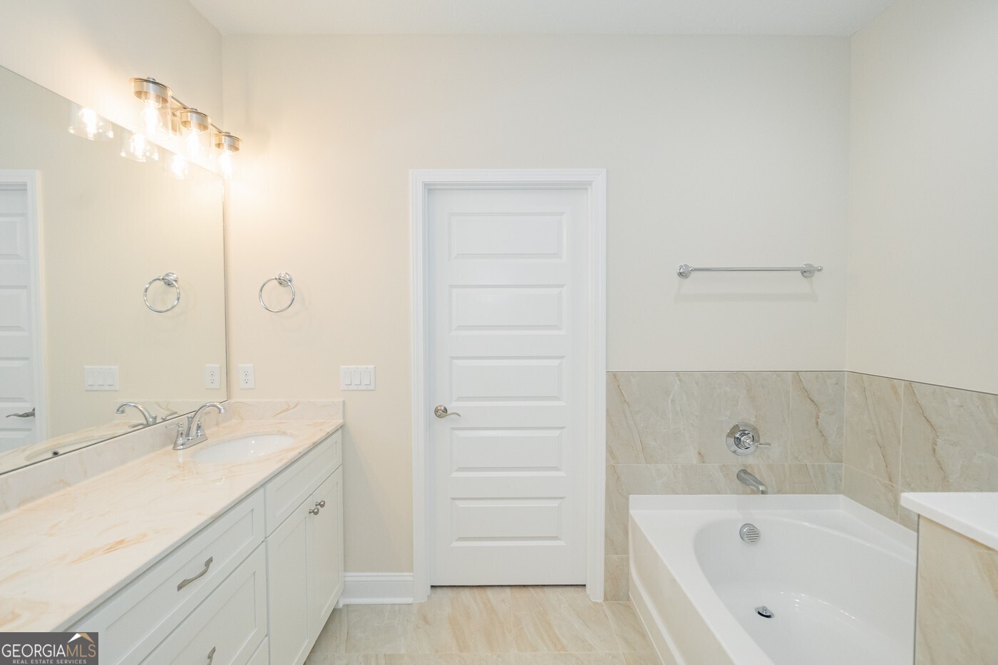 214 The Villas Way Kingsland, GA 31548 - Photo 25 of 47 a bathroom with a tub sink and mirror