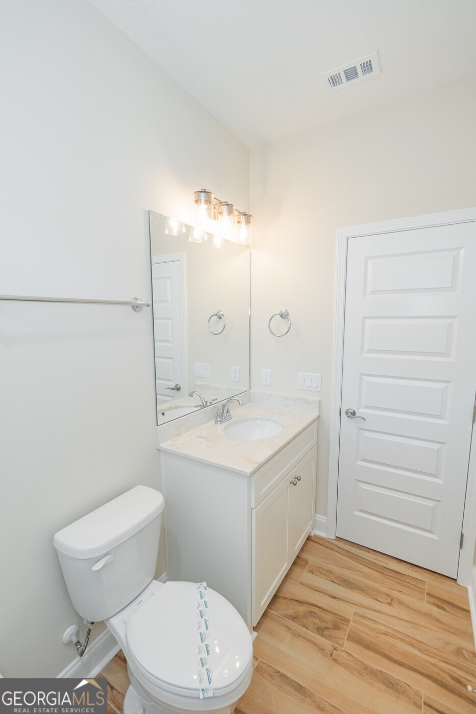 214 The Villas Way Kingsland, GA 31548 - Photo 36 of 47 a bathroom with a sink a toilet a mirror and vanity