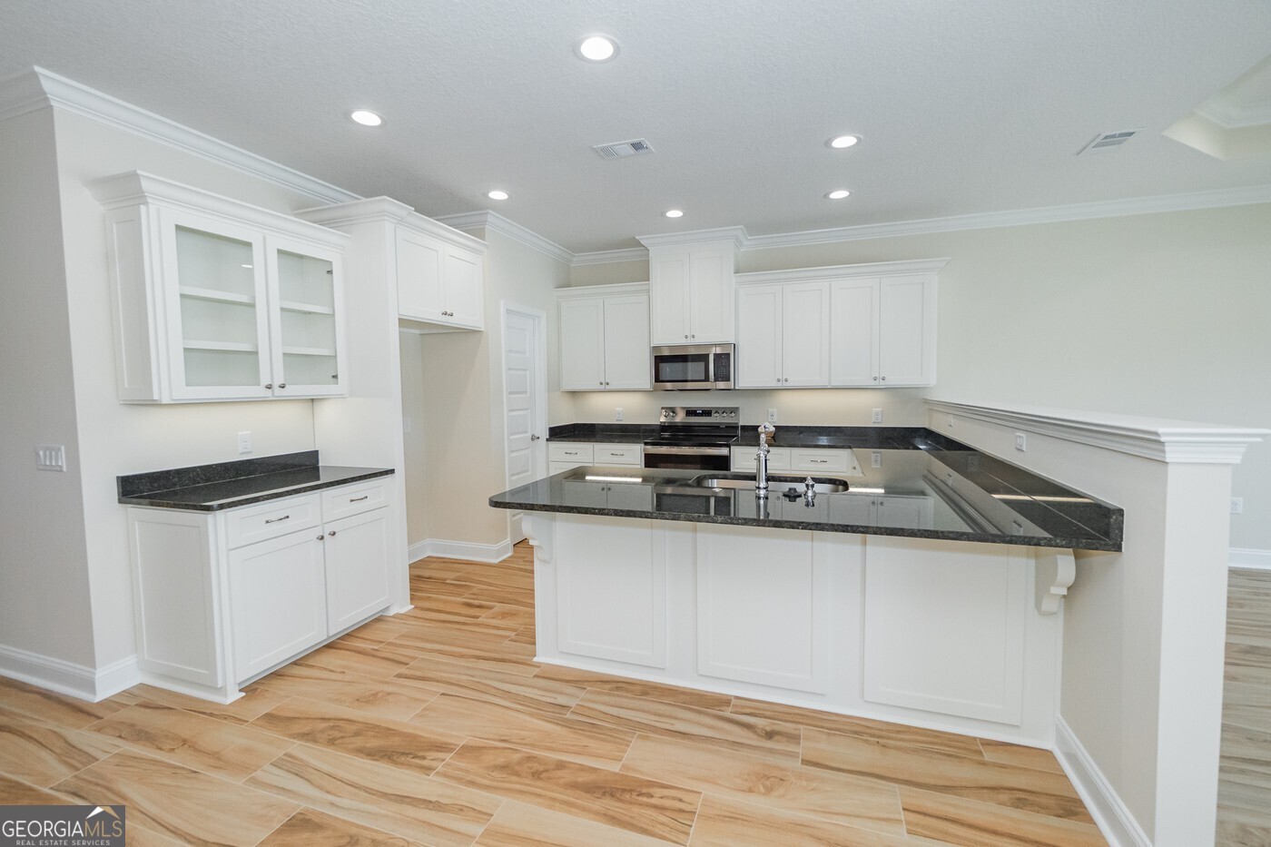 214 The Villas Way Kingsland, GA 31548 - Photo 4 of 47 a kitchen with stainless steel appliances granite countertop a stove and a refrigerator