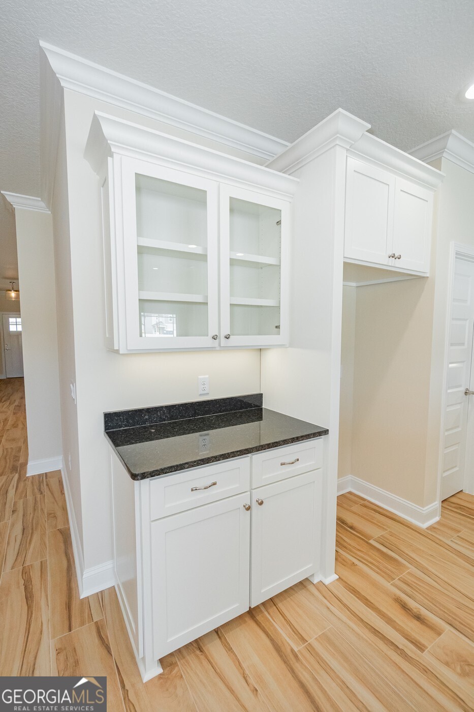 214 The Villas Way Kingsland, GA 31548 - Photo 5 of 47 a kitchen with granite countertop white cabinets and a wooden floor
