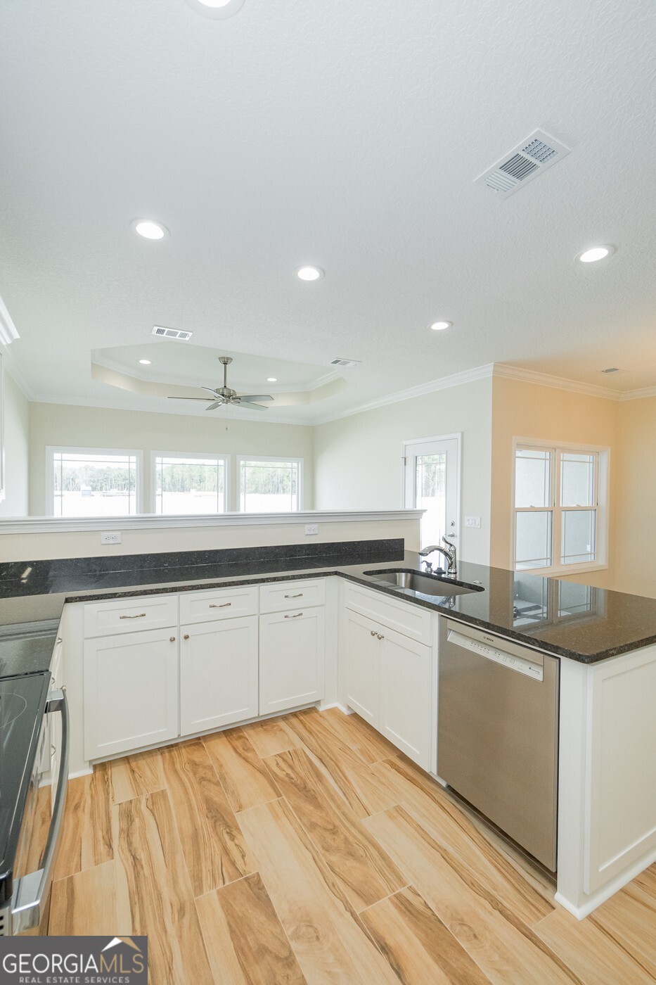 214 The Villas Way Kingsland, GA 31548 - Photo 7 of 47 a kitchen with granite countertop a sink and cabinets