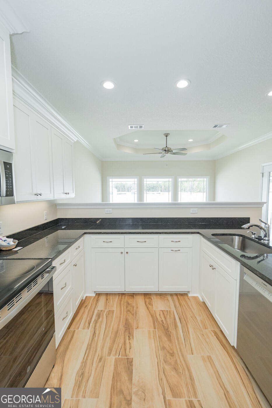 214 The Villas Way Kingsland, GA 31548 - Photo 8 of 47 a kitchen with a sink stove and cabinets