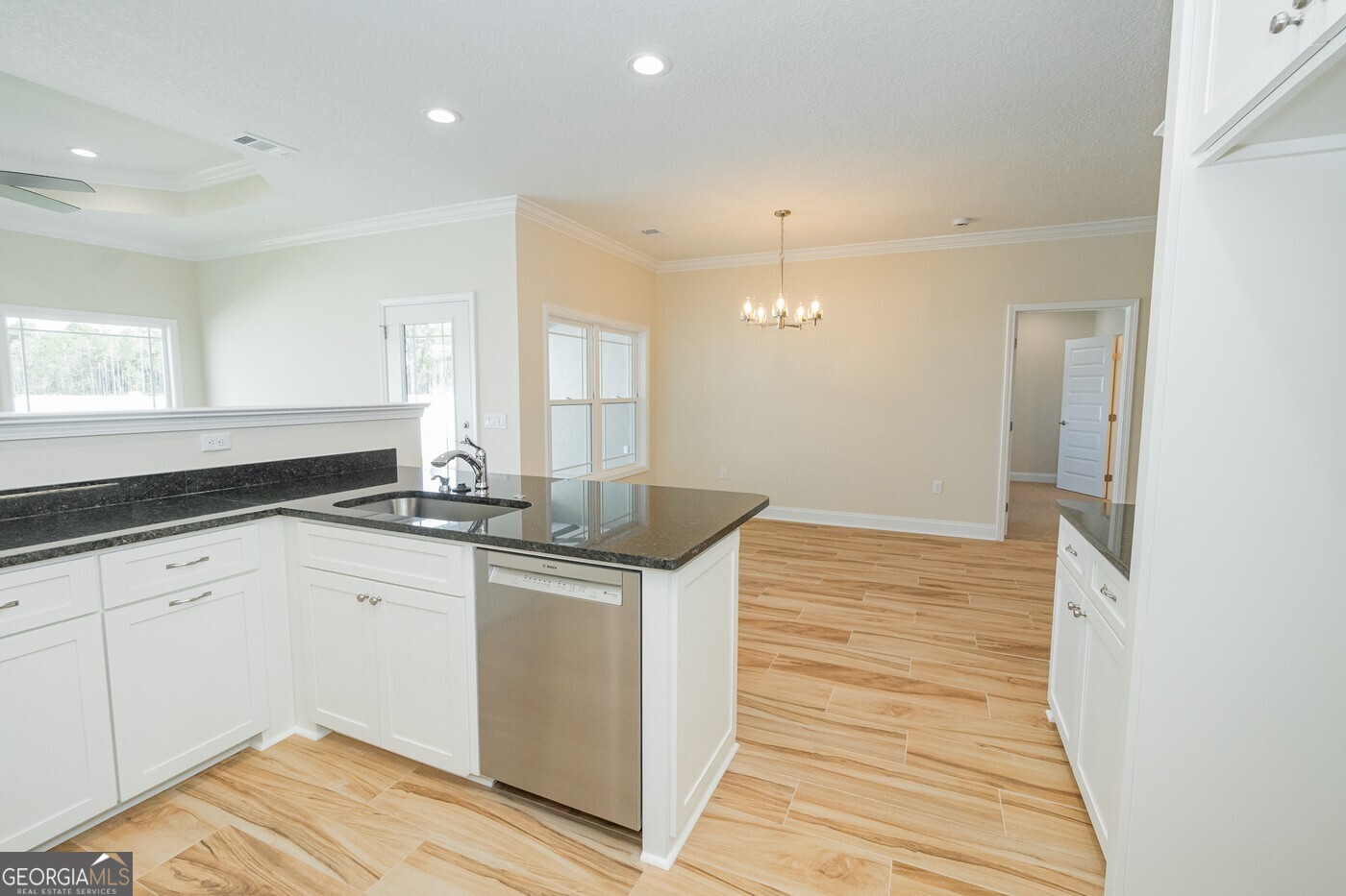 214 The Villas Way Kingsland, GA 31548 - Photo 10 of 47 a kitchen with stainless steel appliances granite countertop a sink and cabinets with wooden floor