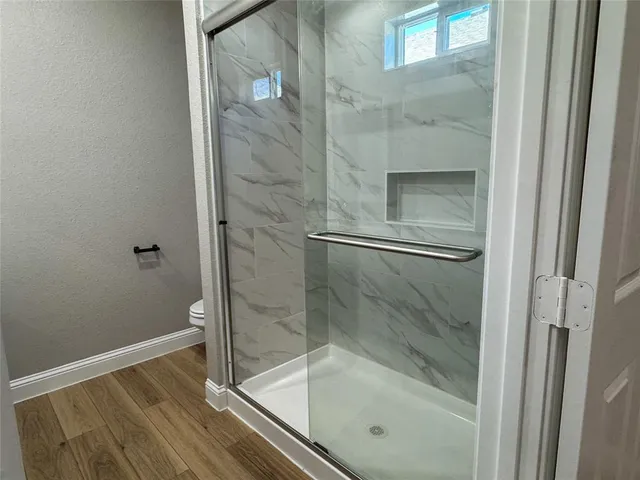 a bathroom with a glass shower door