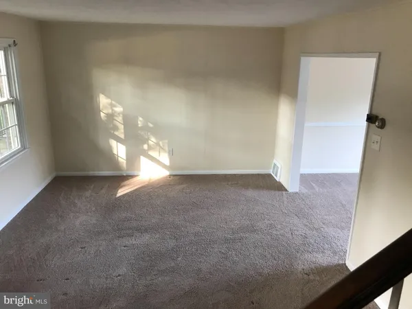 an empty room with windows and entrance