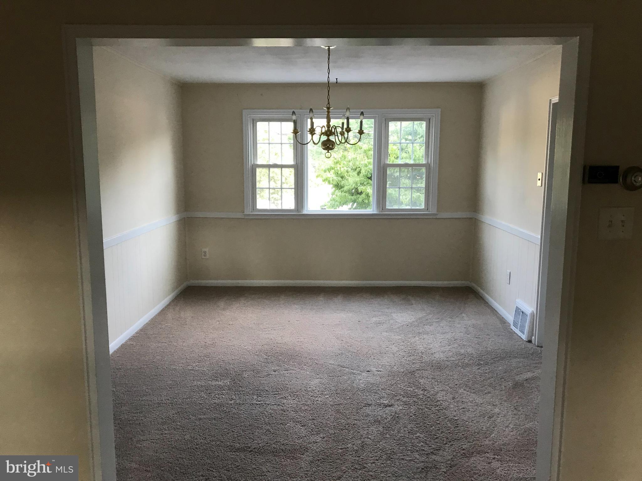 205 Sycamore Road Reading, PA 19611 - Photo 4 of 8 an empty room with windows and chandelier