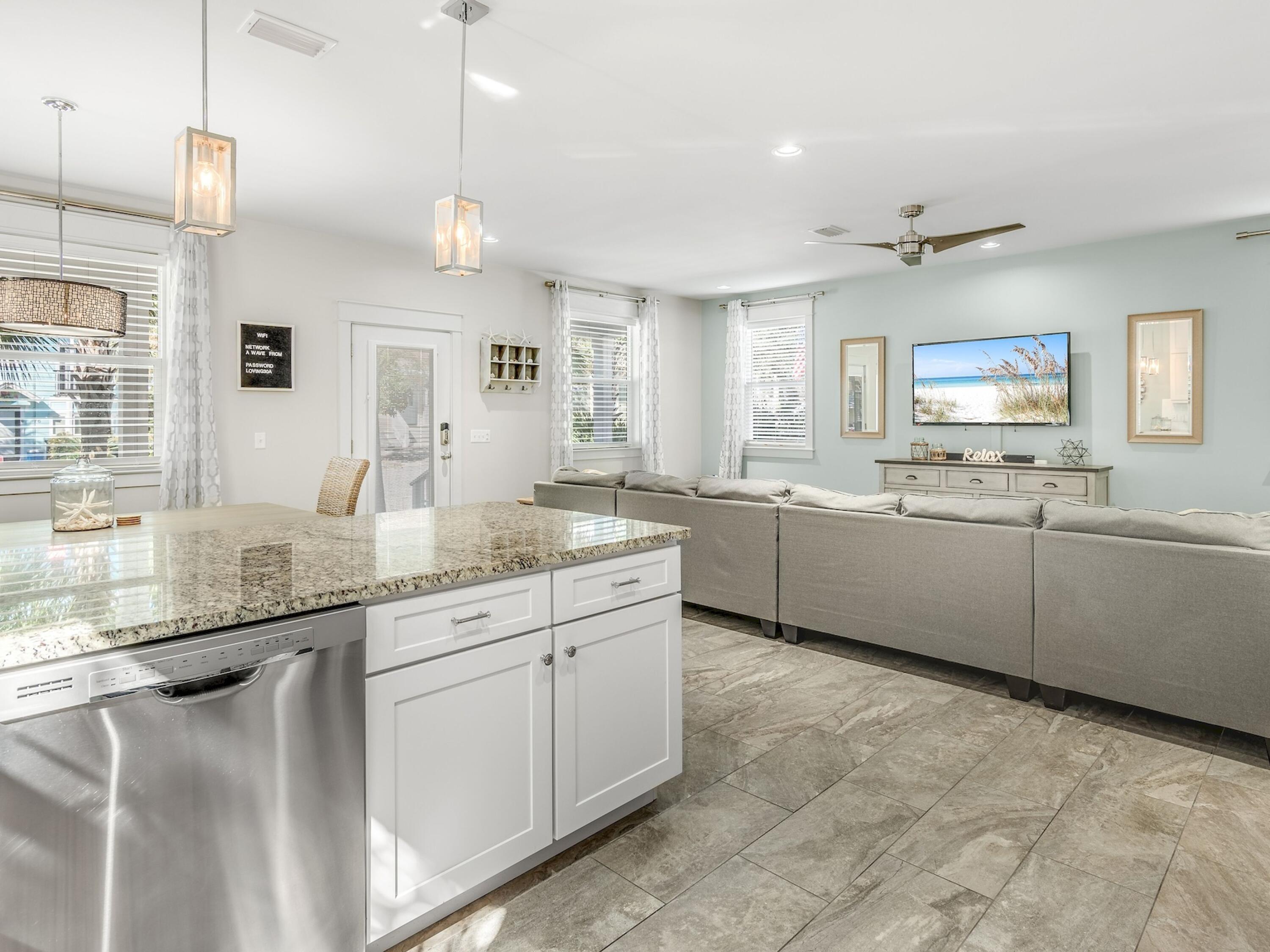 77 Snapper Street Santa Rosa Beach, FL 32459 - Photo 17 of 54 a kitchen with granite countertop a sink and white cabinets