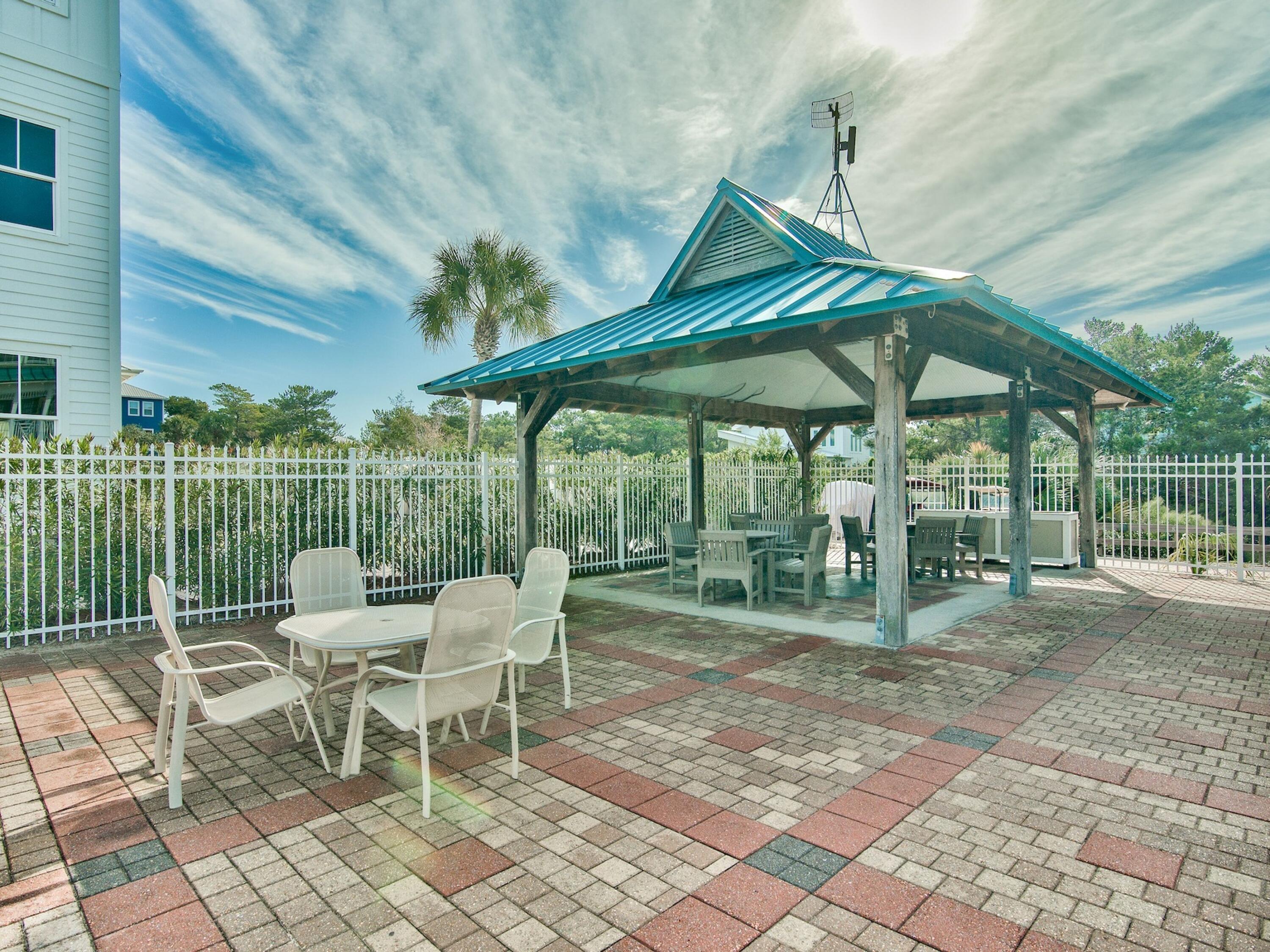 77 Snapper Street Santa Rosa Beach, FL 32459 - Photo 37 of 54 a patio with a yard table and chairs