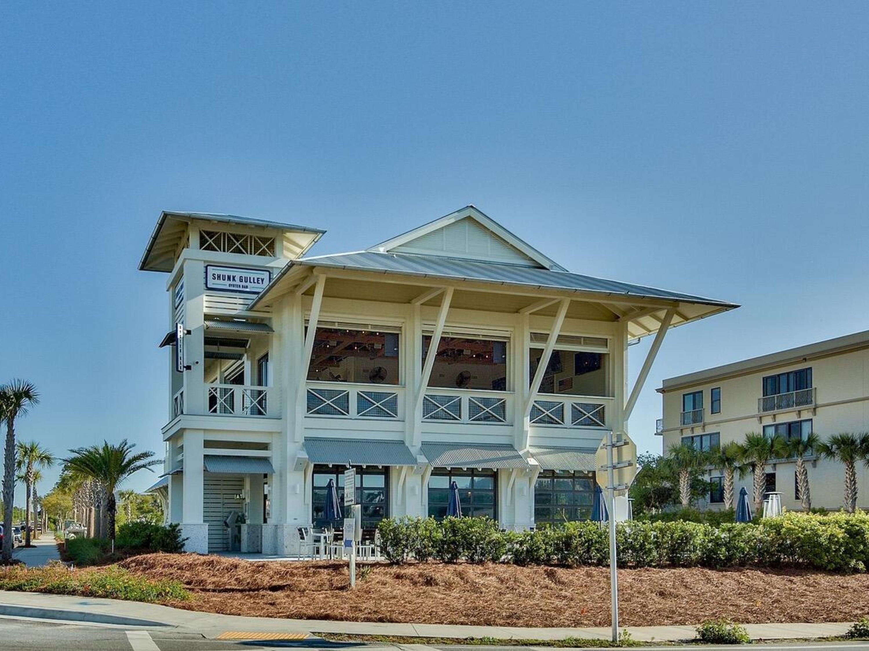 77 Snapper Street Santa Rosa Beach, FL 32459 - Photo 54 of 54 a front view of a residential apartment building with a yard