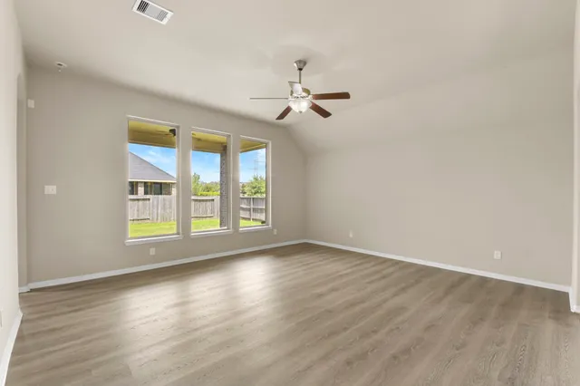 wooden floor in an empty room with a window