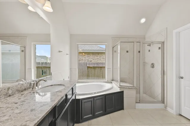 a bathroom with a white bath tub and shower
