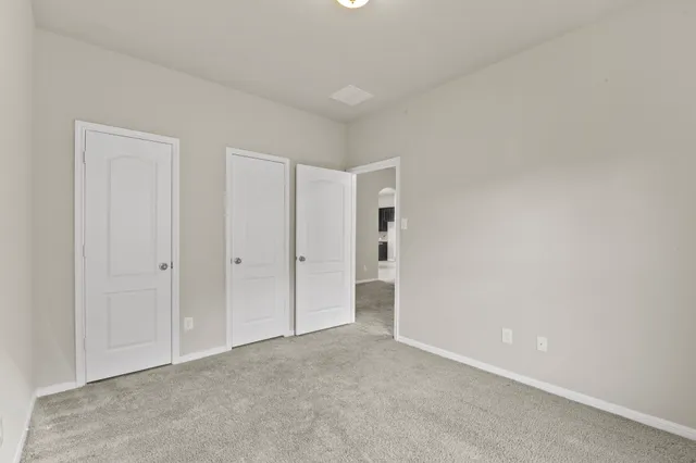 a view of a yard with a large tree and wooden fence