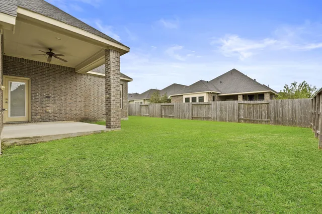 a front view of house with backyard and green space
