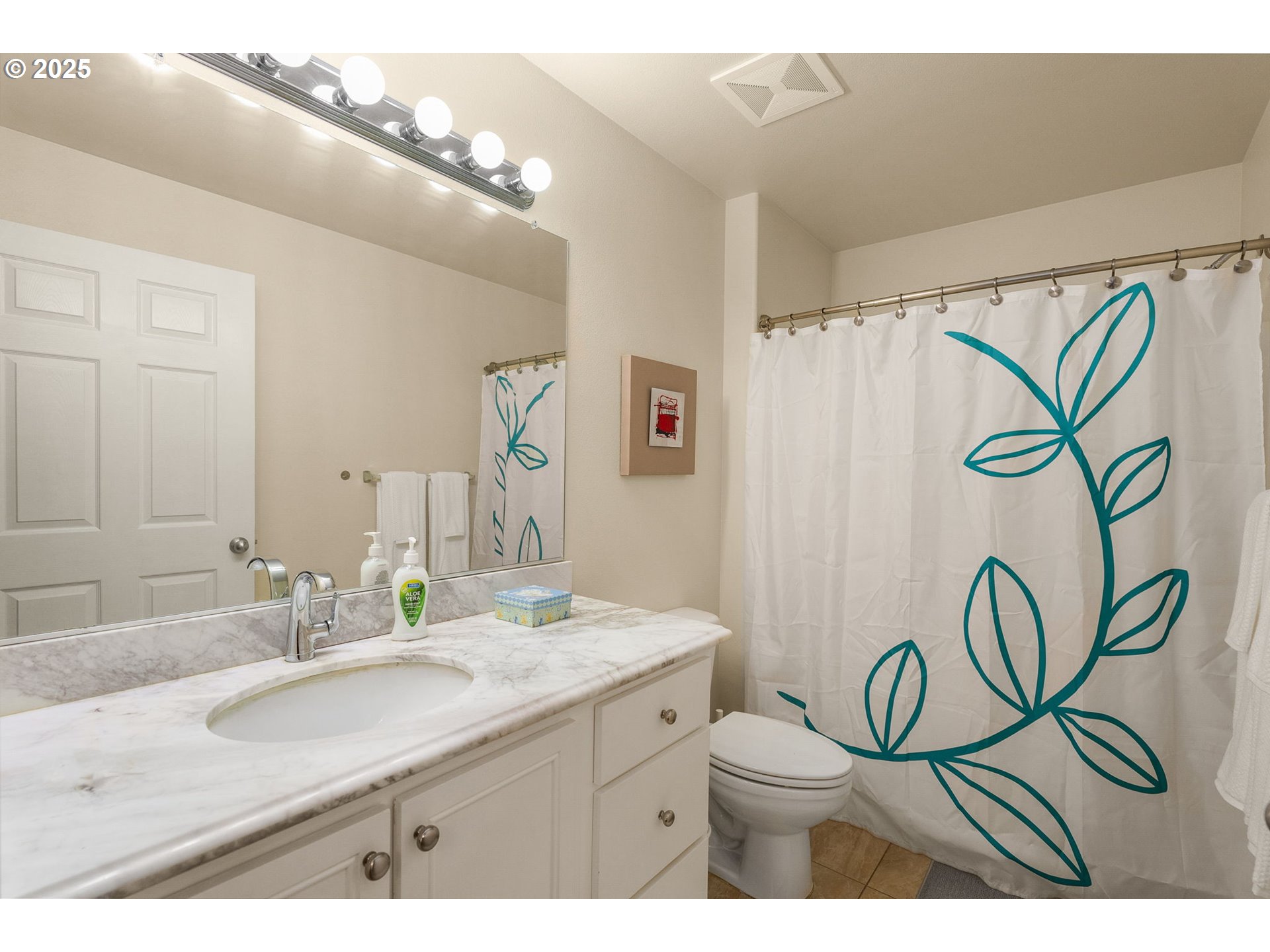 4540 Southwest 11th Street Gresham, OR 97080 - Photo 15 of 27 a bathroom with a granite countertop sink a mirror a vanity and a shower