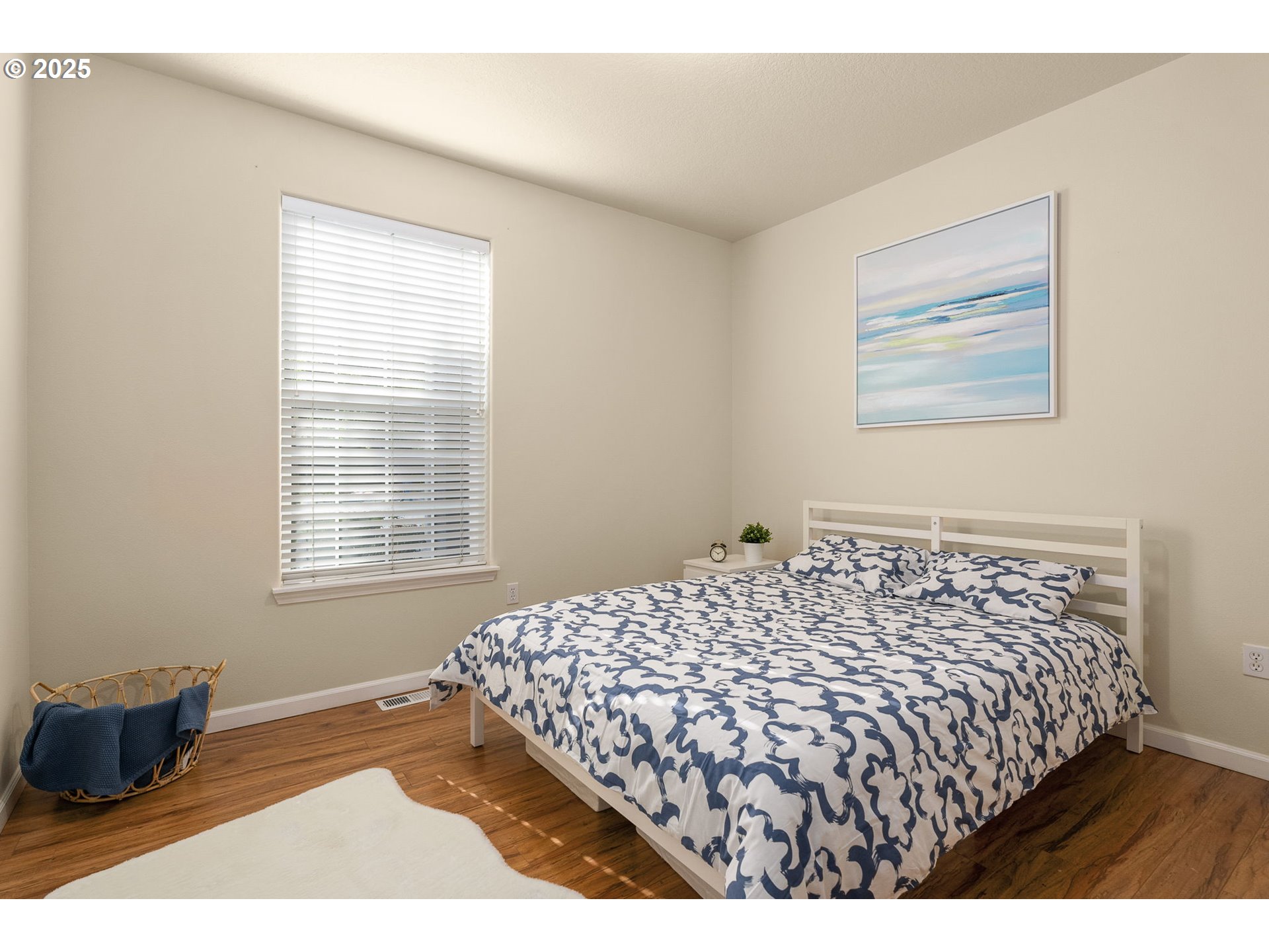 4540 Southwest 11th Street Gresham, OR 97080 - Photo 16 of 27 a bed sitting in a bedroom next to a window