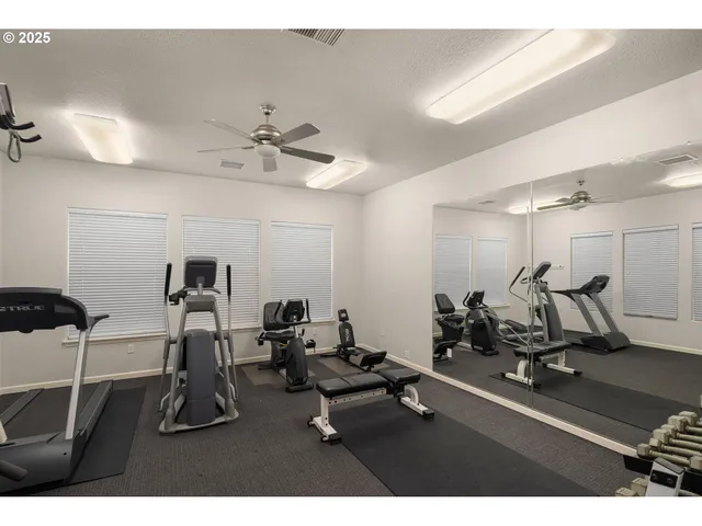 a room with gym equipment and windows