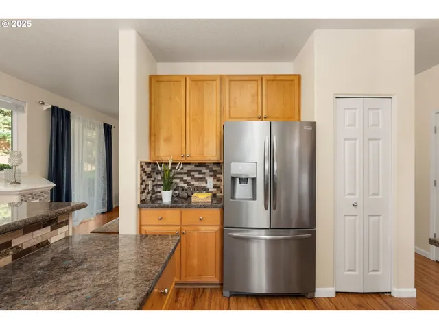 a kitchen with stainless steel appliances a refrigerator and a stove