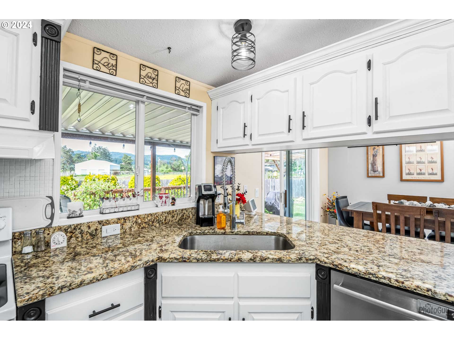 90640 Marcola Road Springfield, OR 97478 - Photo 3 of 40 a view of a kitchen with granite countertop a sink and a large window