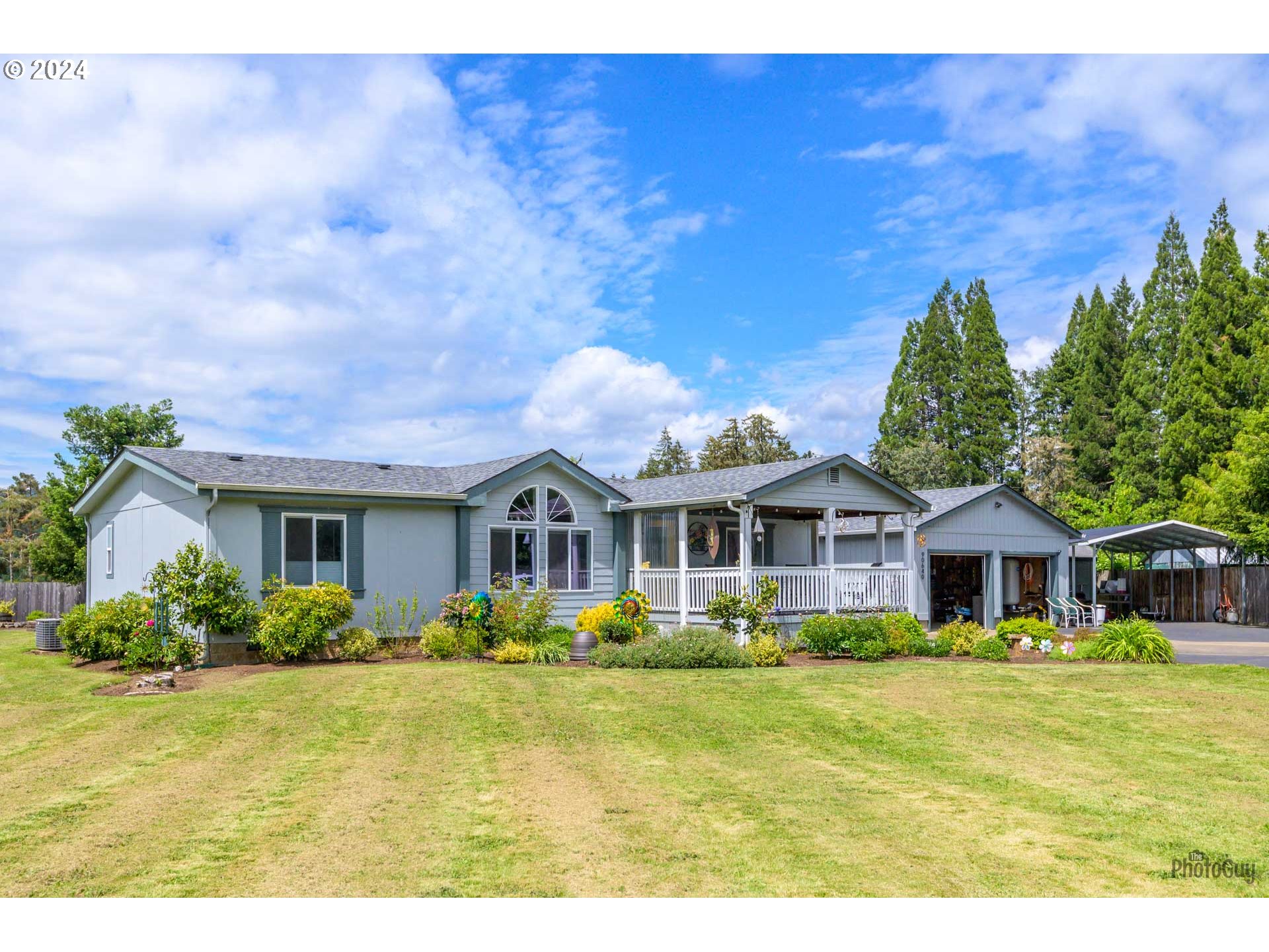 90640 Marcola Road Springfield, OR 97478 - Photo 35 of 40 a front view of house with yard and trees in the background