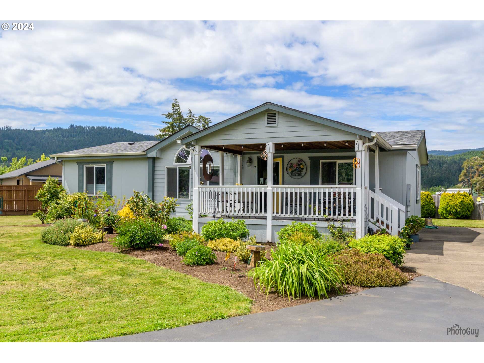 90640 Marcola Road Springfield, OR 97478 - Photo 4 of 40 a view of a house with a flower garden
