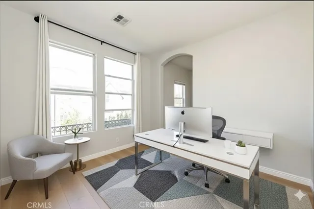 a spacious bedroom with a bed a couch and a view of living room