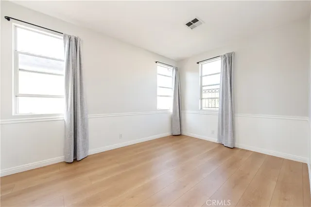 an empty room with wooden floor