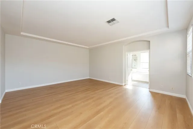 a view of a room with wooden floor and a window