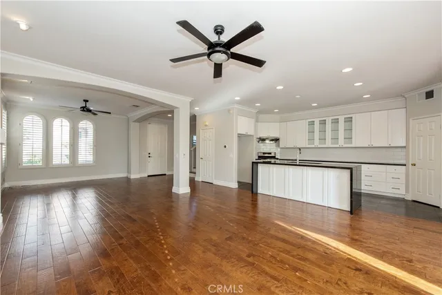 a living room with furniture a wooden floor and a floor to ceiling window