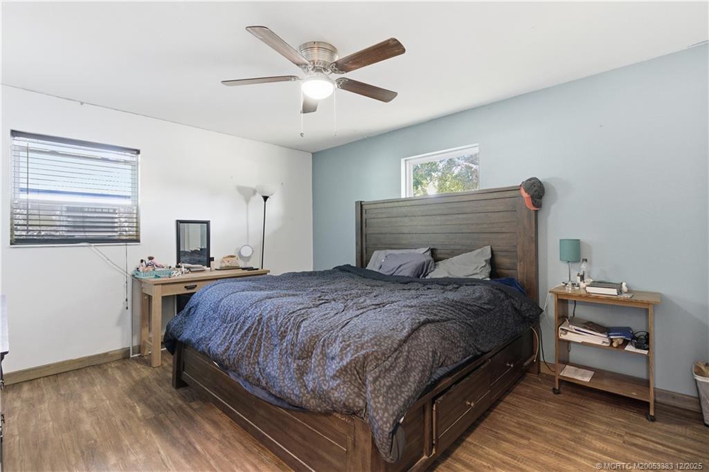 3031 Northwest 2nd Street Okeechobee, FL 34972 - Photo 12 of 19 a bedroom with a bed and a chandelier