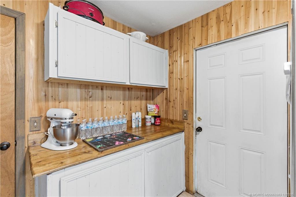 3031 Northwest 2nd Street Okeechobee, FL 34972 - Photo 16 of 19 a kitchen with a refrigerator and a stove